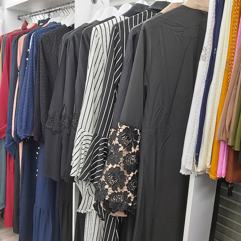 Rail of women's abayas and modest dresses in pink, blue and patterned fabrics